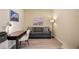 Office room with grey sofa, desk, office chair, and turtle painting at 8579 54Th Avenue E Cir, Bradenton, FL 34211