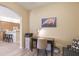 View of an office leading into kitchen with dark wood desk at 8579 54Th Avenue E Cir, Bradenton, FL 34211