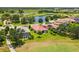 Aerial view of beautiful homes nestled around a scenic lake and a verdant golf course at 8906 Stone Harbour Loop, Bradenton, FL 34212