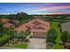 Aerial view of a single-Gathering home with a tile roof, well-manicured landscaping, and a long driveway at 8906 Stone Harbour Loop, Bradenton, FL 34212