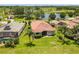 Backyard aerial view with green grass and mature landscaping at 8906 Stone Harbour Loop, Bradenton, FL 34212