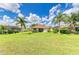 Expansive backyard featuring lush lawn, mature landscaping, and a private setting at 8906 Stone Harbour Loop, Bradenton, FL 34212