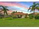 Lush backyard with mature landscaping and a screened lanai, perfect for outdoor entertaining at 8906 Stone Harbour Loop, Bradenton, FL 34212