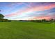Expansive lawn with a serene lake view, offering a peaceful and picturesque setting at 8906 Stone Harbour Loop, Bradenton, FL 34212