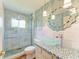 Modern bathroom featuring a stylish glass bowl sink, mosaic-tiled vanity, and frameless glass shower at 8906 Stone Harbour Loop, Bradenton, FL 34212