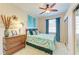 Guest bedroom features a wooden bed frame, bureau, and turquoise accent decorations at 8906 Stone Harbour Loop, Bradenton, FL 34212