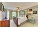 Cozy bedroom features a wooden bed frame, wood-paneled accent wall, and bright natural light at 8906 Stone Harbour Loop, Bradenton, FL 34212