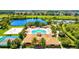 Aerial view of a community pool area with a pool, tennis court, volleyball court and other recreation at 8906 Stone Harbour Loop, Bradenton, FL 34212
