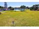 Beautiful green lawn with disc golf basket, walking path, and scenic pond views at this community in Venice, Florida at 8906 Stone Harbour Loop, Bradenton, FL 34212