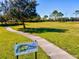 Scenic view of the Heritage Harbour Disc Golf Park, with a paved path at 8906 Stone Harbour Loop, Bradenton, FL 34212