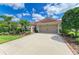 Charming single-story home with well manicured front yard, a two-car garage, and lush landscaping at 8906 Stone Harbour Loop, Bradenton, FL 34212