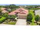 Charming home featuring a red tile roof, a two-car garage, and lush landscaping in a well-maintained yard at 8906 Stone Harbour Loop, Bradenton, FL 34212