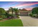 Charming single-story home with a well-manicured lawn, tropical landscaping, and a two-car garage at 8906 Stone Harbour Loop, Bradenton, FL 34212