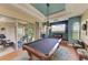 Entertaining game room with pool table, views of screened lanai, and stylish lighting at 8906 Stone Harbour Loop, Bradenton, FL 34212