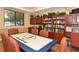 Game room with a large table and built in bookcase at 8906 Stone Harbour Loop, Bradenton, FL 34212