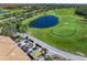 Picturesque aerial view of the golf course featuring a tranquil pond, lush greens, and scenic fairways at 8906 Stone Harbour Loop, Bradenton, FL 34212