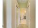 Bright hallway leading to a bathroom featuring a luxurious clawfoot tub and stylish fixtures at 8906 Stone Harbour Loop, Bradenton, FL 34212