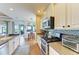 Bright kitchen with stainless appliances, mosaic backsplash and view to dining area at 8906 Stone Harbour Loop, Bradenton, FL 34212