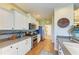 Charming kitchen featuring white cabinets, stainless steel appliances, and mosaic tile backsplash at 8906 Stone Harbour Loop, Bradenton, FL 34212