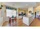 Cozy kitchen with breakfast table and white cabinetry and view into dining area at 8906 Stone Harbour Loop, Bradenton, FL 34212