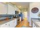 Charming kitchen featuring white cabinets, stainless steel appliances, and mosaic tile backsplash at 8906 Stone Harbour Loop, Bradenton, FL 34212