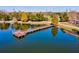 Aerial view of the serene lake and fishing pier surrounded by mature trees at this community in Venice, Florida at 8906 Stone Harbour Loop, Bradenton, FL 34212