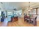 Open-concept living and dining area with lots of natural light, hardwood floors, and tray ceilings at 8906 Stone Harbour Loop, Bradenton, FL 34212