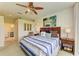 Serene bedroom featuring a comfortable bed, stylish decor, and an open doorway to an elegant bathroom at 8906 Stone Harbour Loop, Bradenton, FL 34212