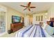 Spacious bedroom with a TV, dresser, and access to a balcony with sliding glass doors at 8906 Stone Harbour Loop, Bradenton, FL 34212