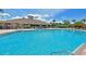 A community pool featuring a nearby clubhouse and lounge seating at 8906 Stone Harbour Loop, Bradenton, FL 34212