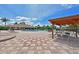 Community pool with nearby clubhouse, lounge seating, and splash pad at 8906 Stone Harbour Loop, Bradenton, FL 34212