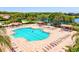 Community pool featuring ample lounge seating, covered picnic areas, and lush landscaping with water views at 8906 Stone Harbour Loop, Bradenton, FL 34212