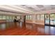 A recreation room featuring hardwood floors, neutral paint, and access to the outdoor pool area at 8906 Stone Harbour Loop, Bradenton, FL 34212