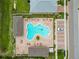 Aerial view of the community pool, featuring lounge chairs and a nearby parking lot at 8937 Excelsior Loop, Venice, FL 34293