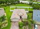 Beautiful home on a manicured lawn featuring mature landscaping and a paver driveway at 8937 Excelsior Loop, Venice, FL 34293