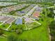 Aerial view of the neighborhood with many houses and a lake at 8937 Excelsior Loop, Venice, FL 34293