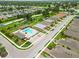 Aerial view of a community pool, parking area, and surrounding neighborhood homes at 8937 Excelsior Loop, Venice, FL 34293