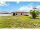 Spacious backyard with healthy grass, perfect for outdoor activities, complemented by a white privacy fence at 8937 Excelsior Loop, Venice, FL 34293