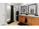 Bright bathroom featuring double sinks, granite countertops, a glass shower and modern finishes at 8937 Excelsior Loop, Venice, FL 34293