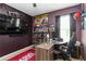 Well-appointed bedroom featuring themed decor, display case, desk, and an abundance of collectible items at 8937 Excelsior Loop, Venice, FL 34293
