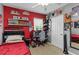 Red and gray bedroom with a ceiling fan, window, and gamer decor at 8937 Excelsior Loop, Venice, FL 34293
