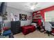 This bedroom is painted with modern neutral colors and has a red accent wall at 8937 Excelsior Loop, Venice, FL 34293