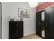A walk-in closet with a black dresser, wardrobe, and decorative accents at 8937 Excelsior Loop, Venice, FL 34293