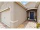 Home featuring an attached two-car garage and covered front entry at 8937 Excelsior Loop, Venice, FL 34293