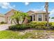 Charming single-story home with lush tropical landscaping and a paver driveway at 8937 Excelsior Loop, Venice, FL 34293