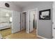 Hallway with neutral paint, leading to bedroom, closet, and bathroom at 8937 Excelsior Loop, Venice, FL 34293