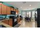 Open kitchen with black appliances, tile flooring, and view to dining area at 8937 Excelsior Loop, Venice, FL 34293