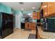 Open concept kitchen featuring black appliances and lots of counter space at 8937 Excelsior Loop, Venice, FL 34293