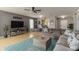 Open-concept living room with stylish furniture, neutral tones, and a seamless flow at 8937 Excelsior Loop, Venice, FL 34293