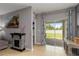 Living area showcasing a fireplace, sliding glass door to the backyard, and neutral palette at 8937 Excelsior Loop, Venice, FL 34293